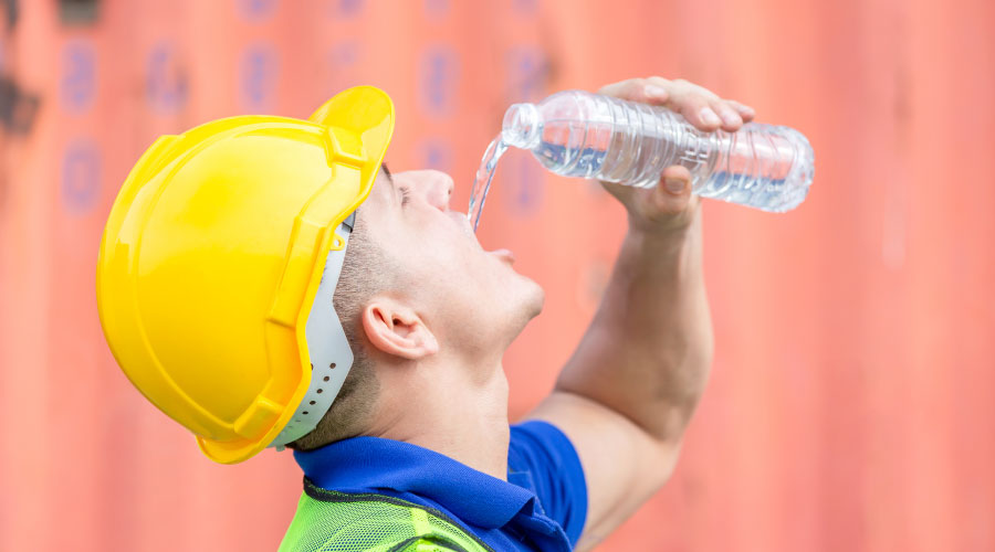 Construction worker drinking water