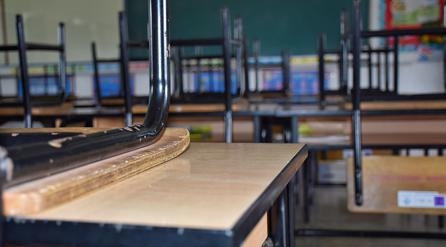 chairs on top of desks in school