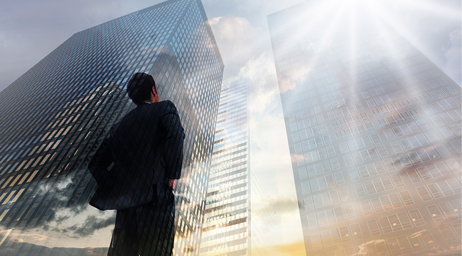 man looking up at buildings